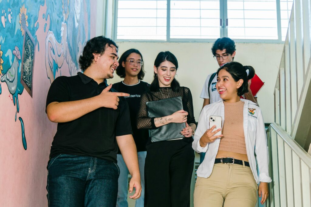 Group of diverse university students engaged in conversation on campus stairs in Culiacán.